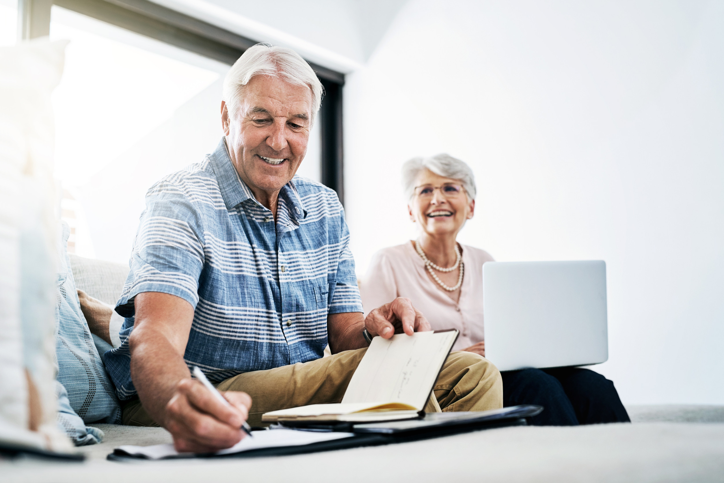 See what happens when you stick to a budget. a senior couple going through their paperwork together at home.