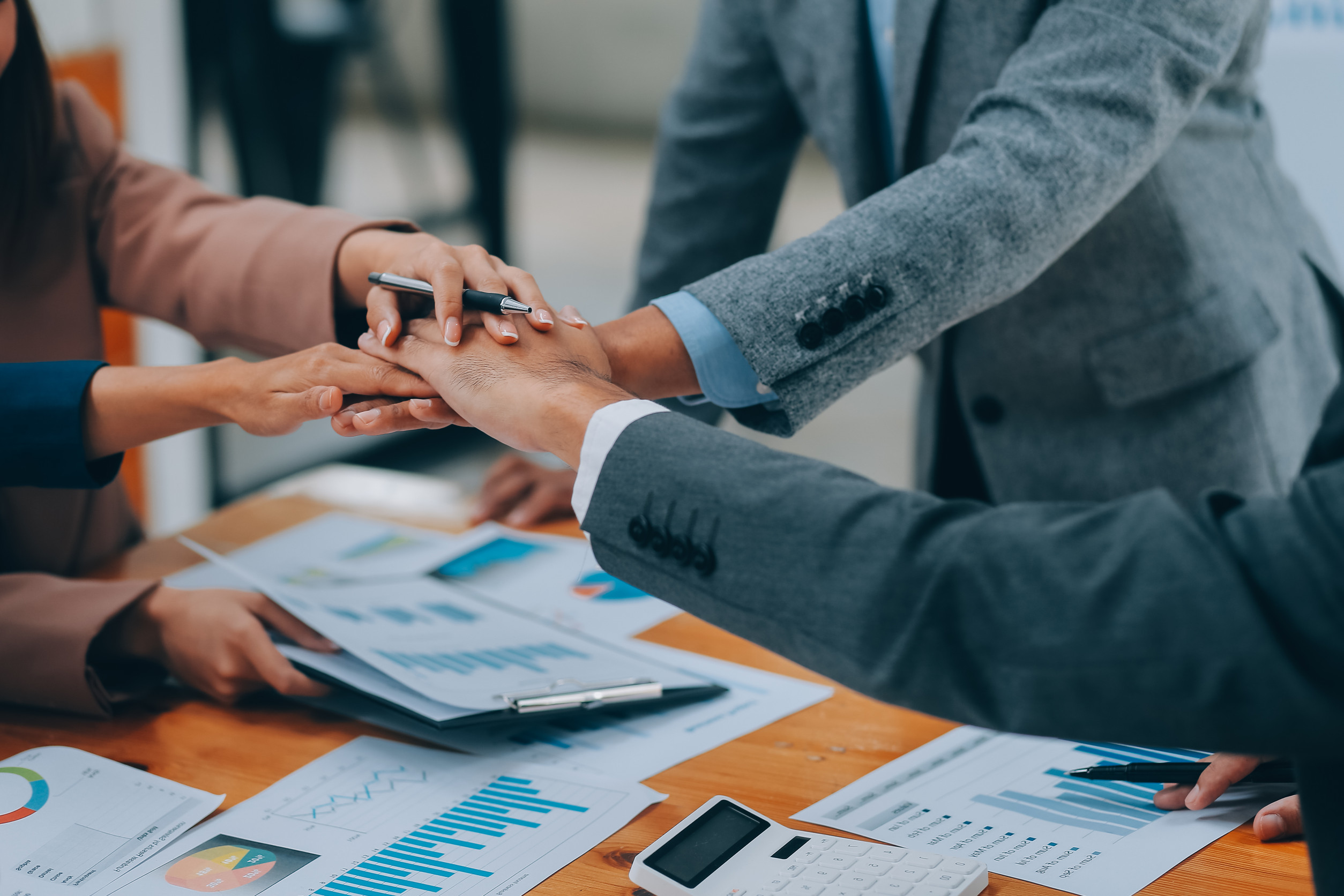Business people join hand together during their meeting