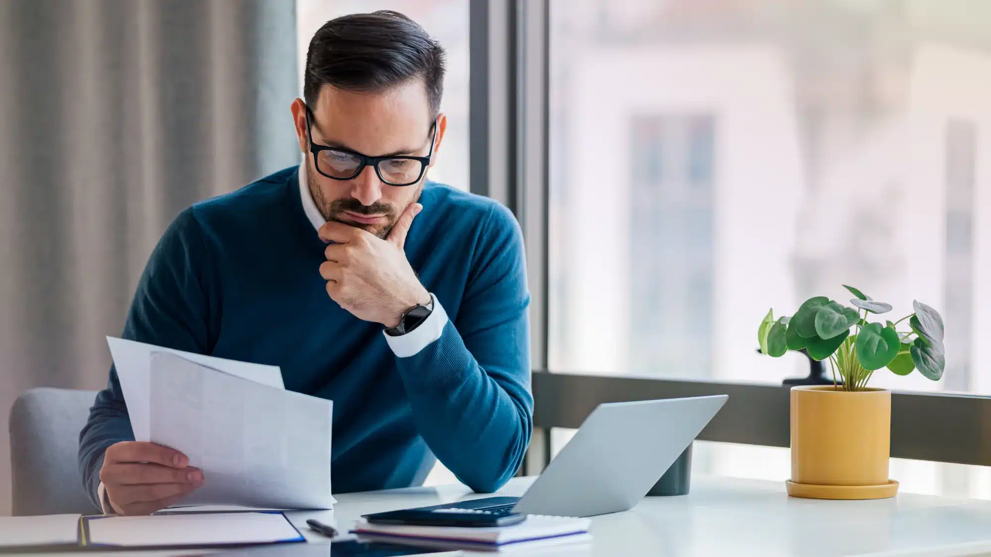 business administrator reviewing pooled employer plan documents and retirement plan dashboard to simplify and optimize company retirement plan management