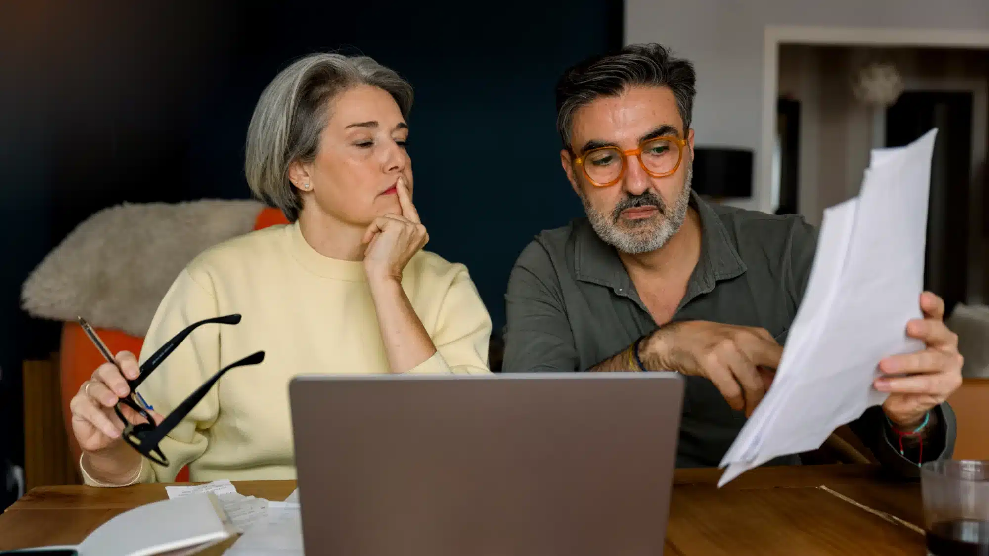 Financial advisor reviewing retirement investment options and long-term savings plans with clients preparing for retirement